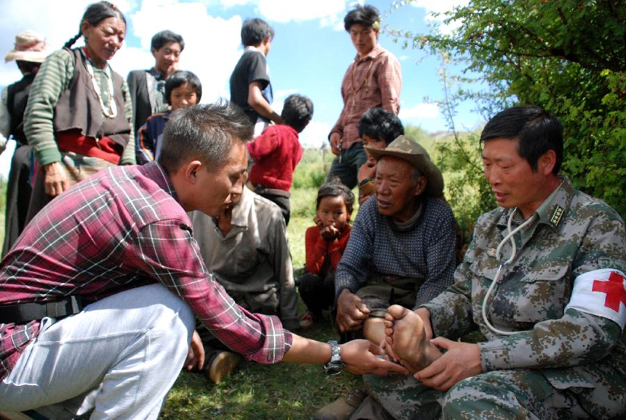 2013年8月16日昌都駐軍醫生在嘎益村為老人治療腿傷