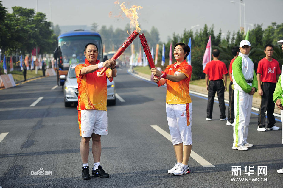 與張鐵林（左）進行聖火交接